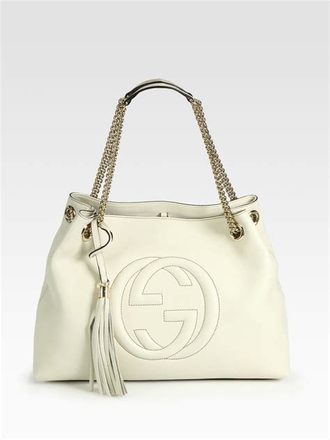 grey and white gucci robe|white Gucci handbag.